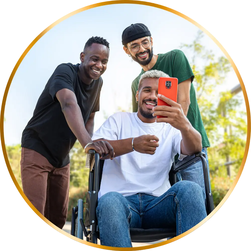 Three friends, one disabled in wheelchair, looking at mobile phone