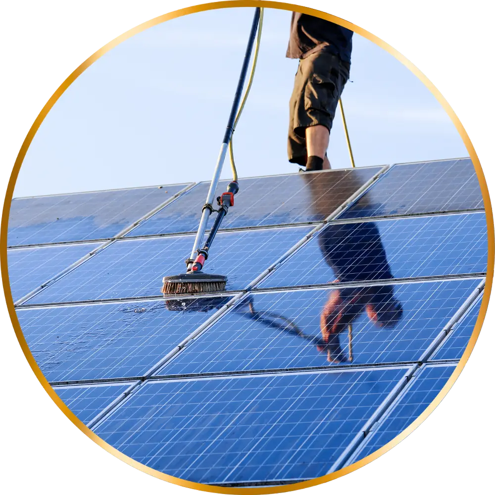 Man cleaning solar panels on roof